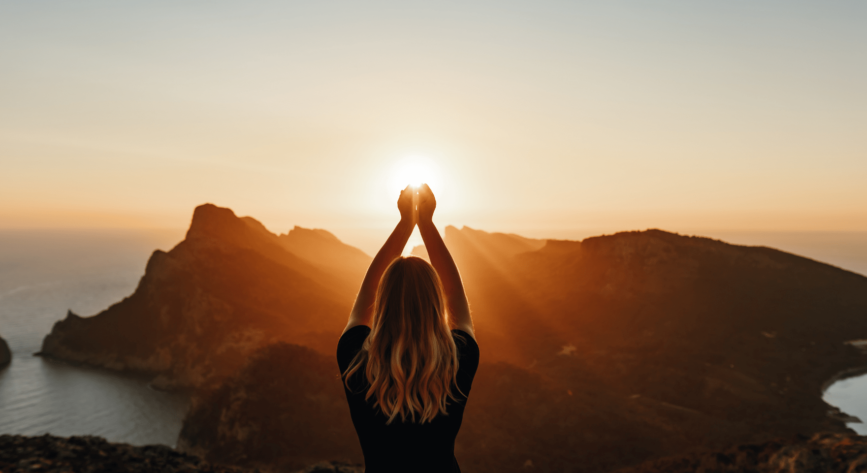 Woman overlooking the sea at sunset